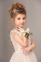 Image showing Little pretty girl with flowers dressed in wedding dresses