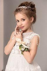 Image showing Little pretty girl with flowers dressed in wedding dresses