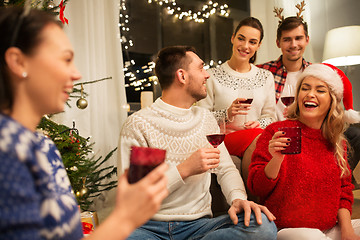 Image showing friends celebrating christmas and drinking wine