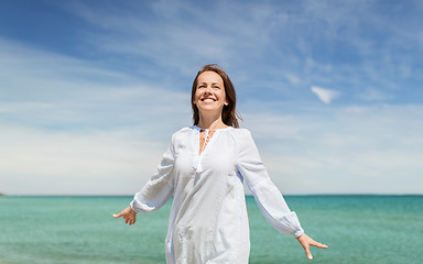 Image showing happy smiling woman on summer beach