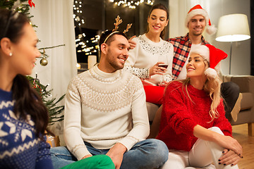 Image showing friends celebrating christmas and drinking wine