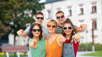 Image showing friends in sunglasses pointing at you