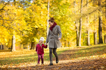 Image showing happy mother and little daughter at autumn park