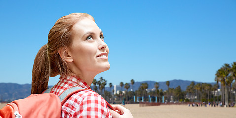 Image showing smiling woman with backpack over venice beach