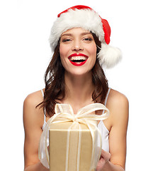 Image showing woman with gift box in santa hat at christmas