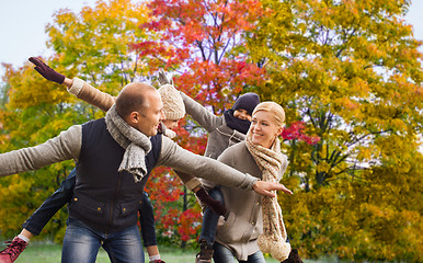 Image showing happy family having fun over autumn park