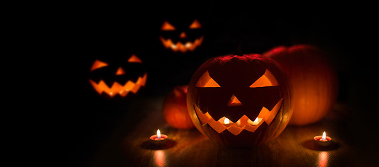 Image showing halloween jack-o-lanterns burning in darkness