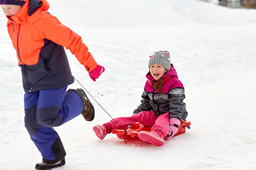 Image showing girls with sled having fun outdoors in winter