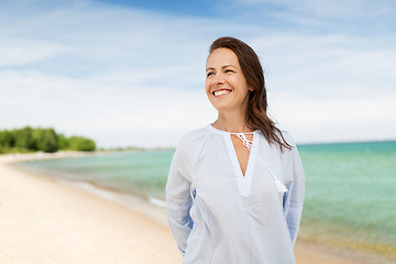 Image showing happy smiling woman on summer beach