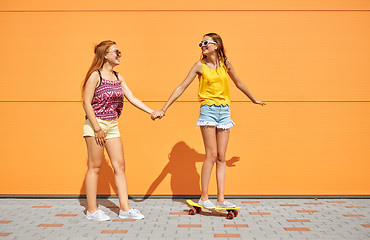 Image showing teenage girls riding skateboard on city street