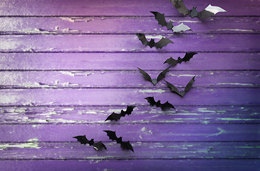 Image showing black bats over ultra violet shabby boards