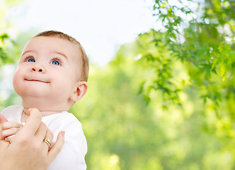 Image showing close up of sweet little baby with mother hand