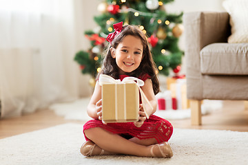 Image showing happy girl with christmas gift at home