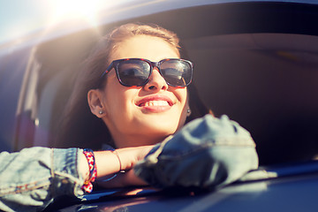 Image showing happy teenage girl or young woman in car