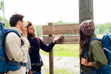 Image showing hiking friends with backpacks at signpost