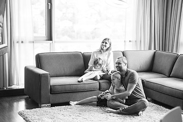 Image showing Happy family playing a video game