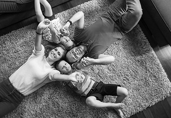 Image showing happy family lying on the floor