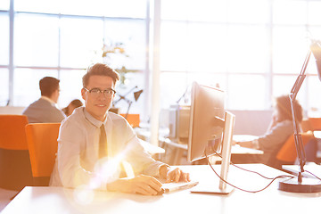 Image showing Young businessman using computer at work