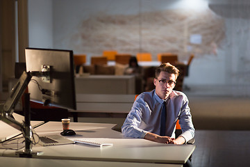 Image showing man working on computer in dark office