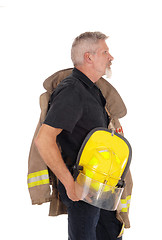 Image showing A firefighter standing in profile 