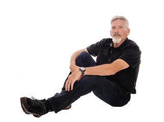 Image showing Middle age man sitting on floor