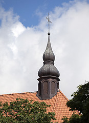 Image showing Golden cross on red tile roof