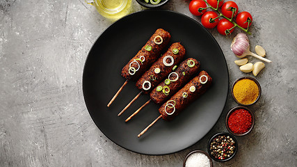 Image showing Barbecued turkey kebab decorated with fresh onion