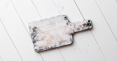 Image showing Wooden chopping board on white board table.