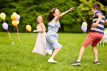 Image showing happy kids playing tag game at birthday party