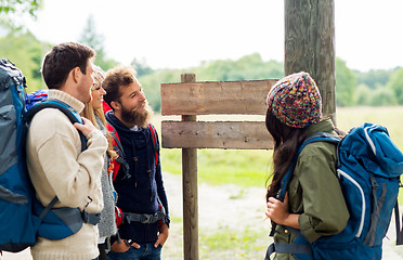 Image showing hiking friends with backpacks at signpost