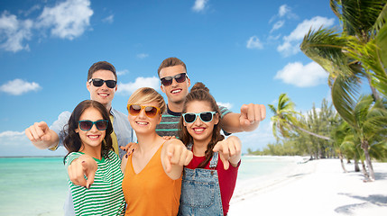 Image showing friends in sunglasses pointing at you over beach