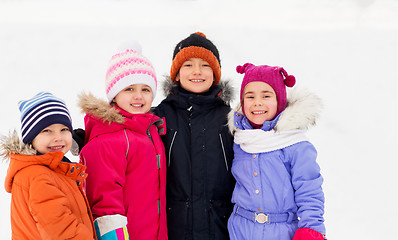 Image showing happy little kids in winter clothes outdoors