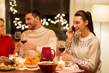 Image showing happy friends having christmas dinner at home