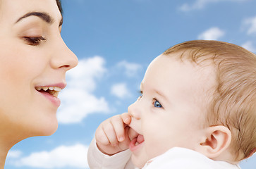 Image showing mother with baby over sky background