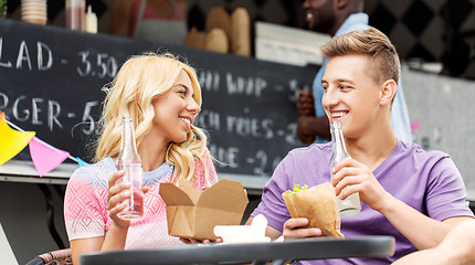 Image showing friends eating and talking at food truck