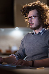 Image showing man working on computer in dark office