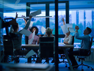 Image showing multiethnic Group of young business people throwing documents