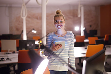 Image showing woman working on digital tablet in night office