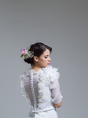 Image showing Rear view of a beautiful young woman in a wedding dress