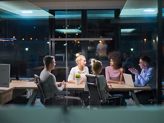 Image showing Multiethnic startup business team in night office