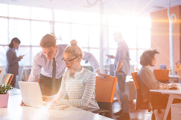 Image showing Young businessman helping his colleague at the work