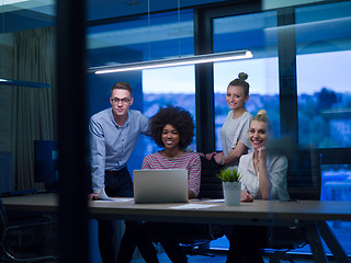 Image showing Multiethnic startup business team in night office