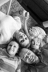 Image showing happy family lying on the floor