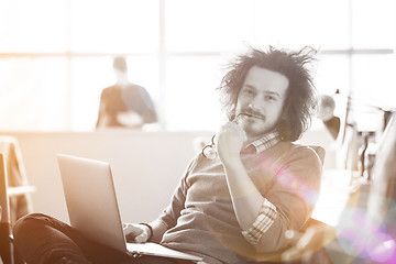 Image showing Young businessman using computer at work