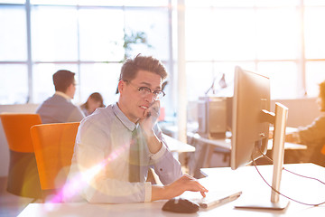 Image showing Young businessman using computer at work