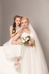 Image showing Little pretty girls with flowers dressed in wedding dresses