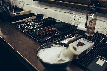 Image showing Barber shop tools on the table. Close up view shaving foam.