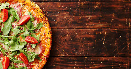 Image showing Delicious italian pizza served on wooden table