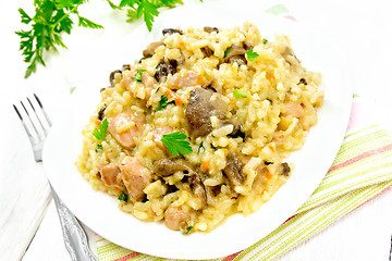 Image showing Risotto with mushrooms and chicken on light board