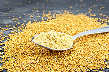 Image showing Mustard powder in spoon on black board
